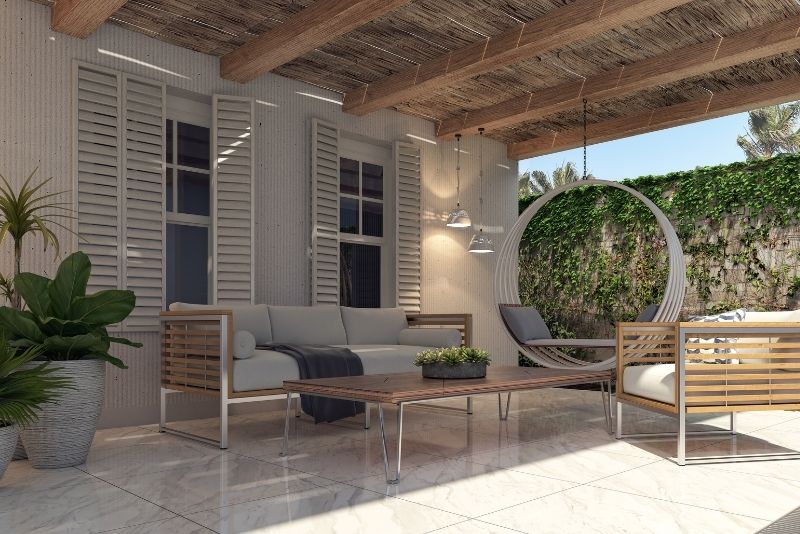 tiled patio with furniture and large plants in the side