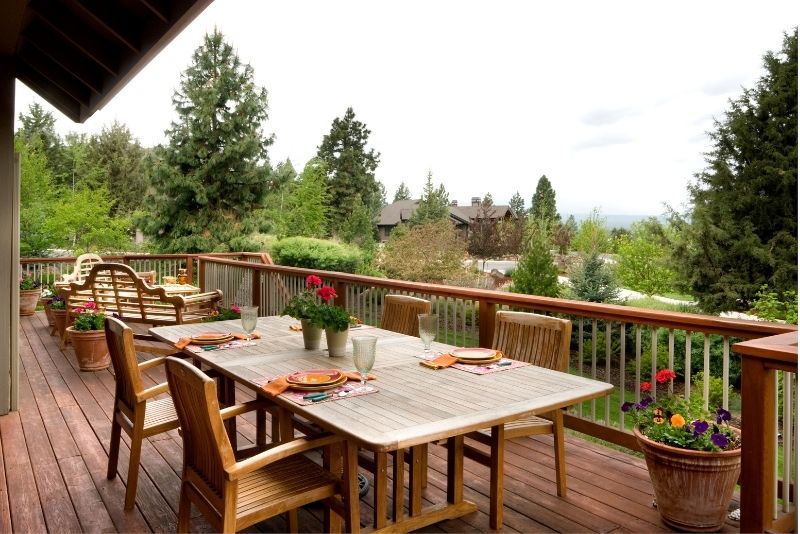 wooden tables and chairs in a patio area