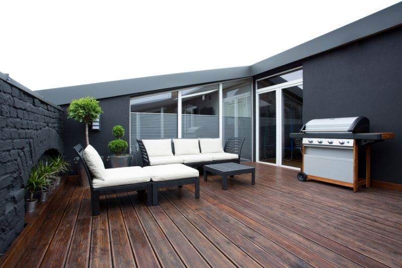 bawbeque area in the patio of the house with timber decking